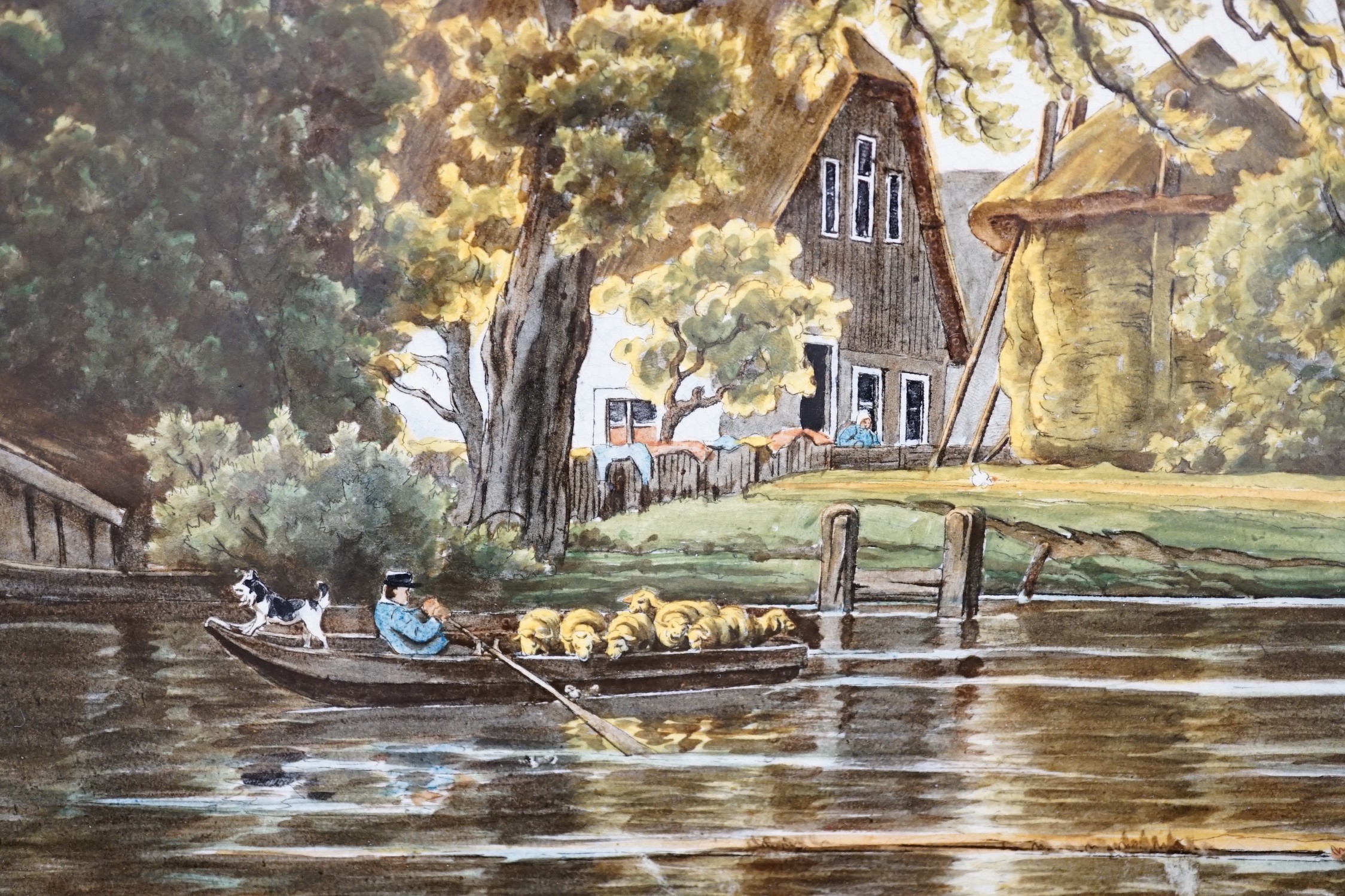 A framed continental ceramic plaque of a figurative country farm river scene, signed, 55cms wide x 35cms high